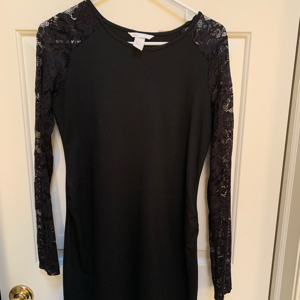 Black maternity dress with black lace sleeves.